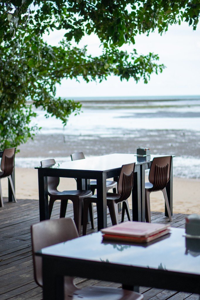 Shaded deck seating with sea view at Branch 2