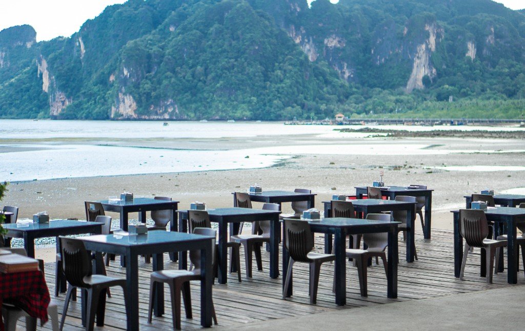 Ocean view deck at KoDam Kitchen Branch 2 with limestone mountains