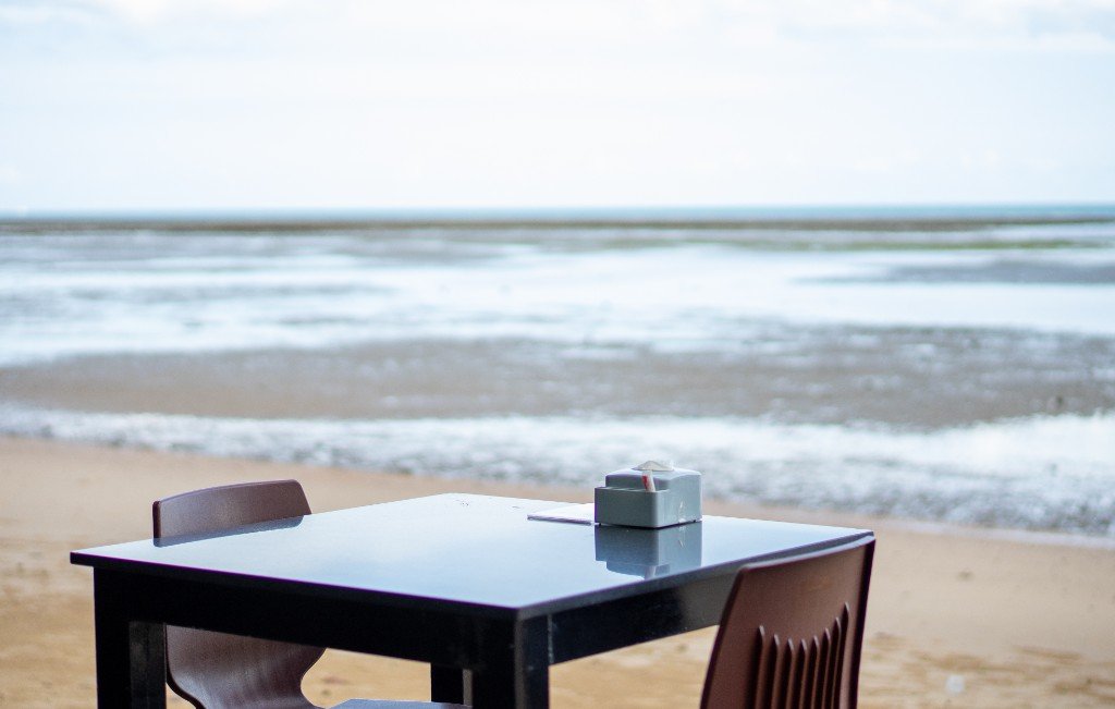 Seaside table set for dining at Branch 2 Oceanview